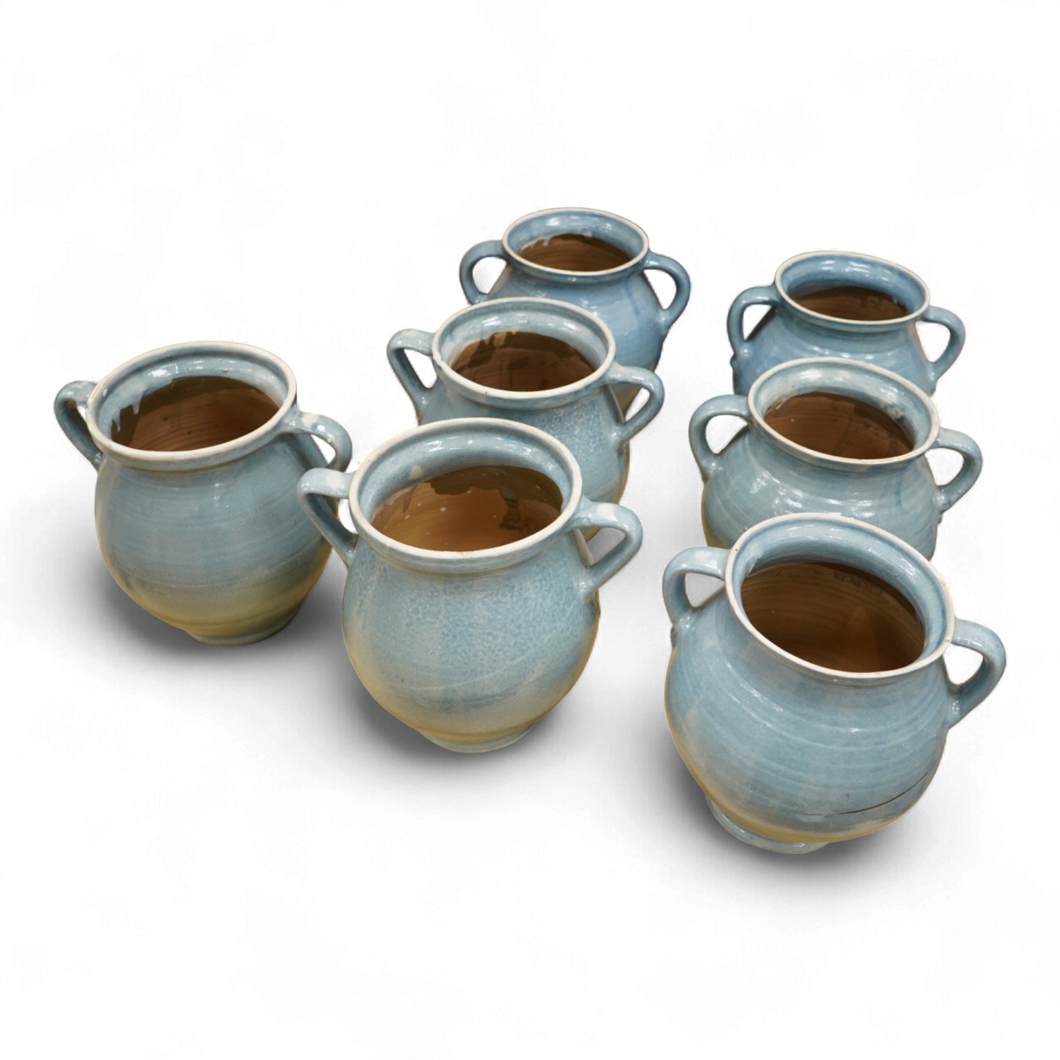 Seven early 20th century Continental blue glazed terracotta twin handled jars, 26cm high